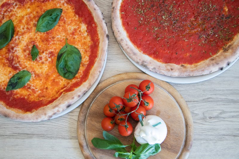 Vegan pizza with cashew cheese and roasted tomatoes